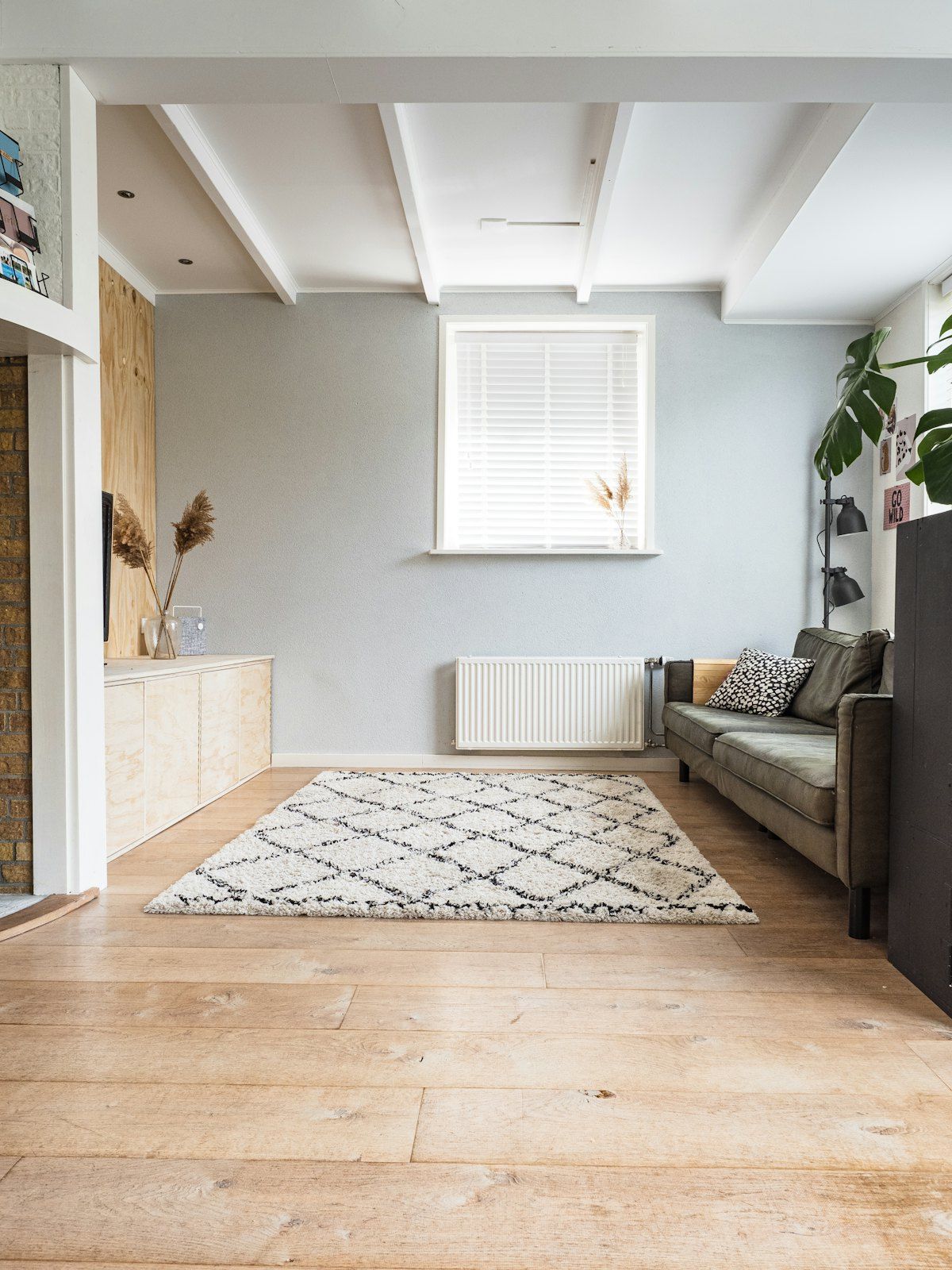 A freshly cleaned living room with the floor swept and the rug straightened